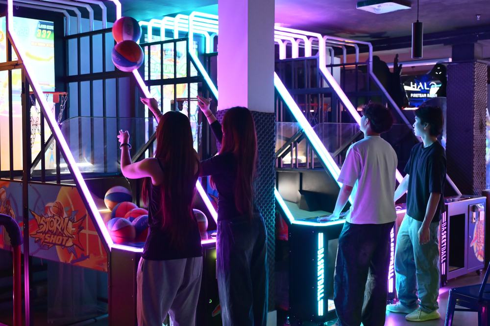 A group playing arcade basketball at Paradigm Zone